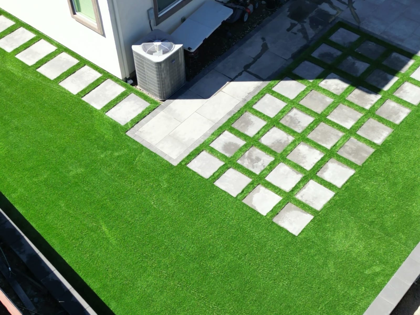 Aerial drone view of a paver patio with artificial turf installed by Royal Outdoor Solutions in Fairfield, California