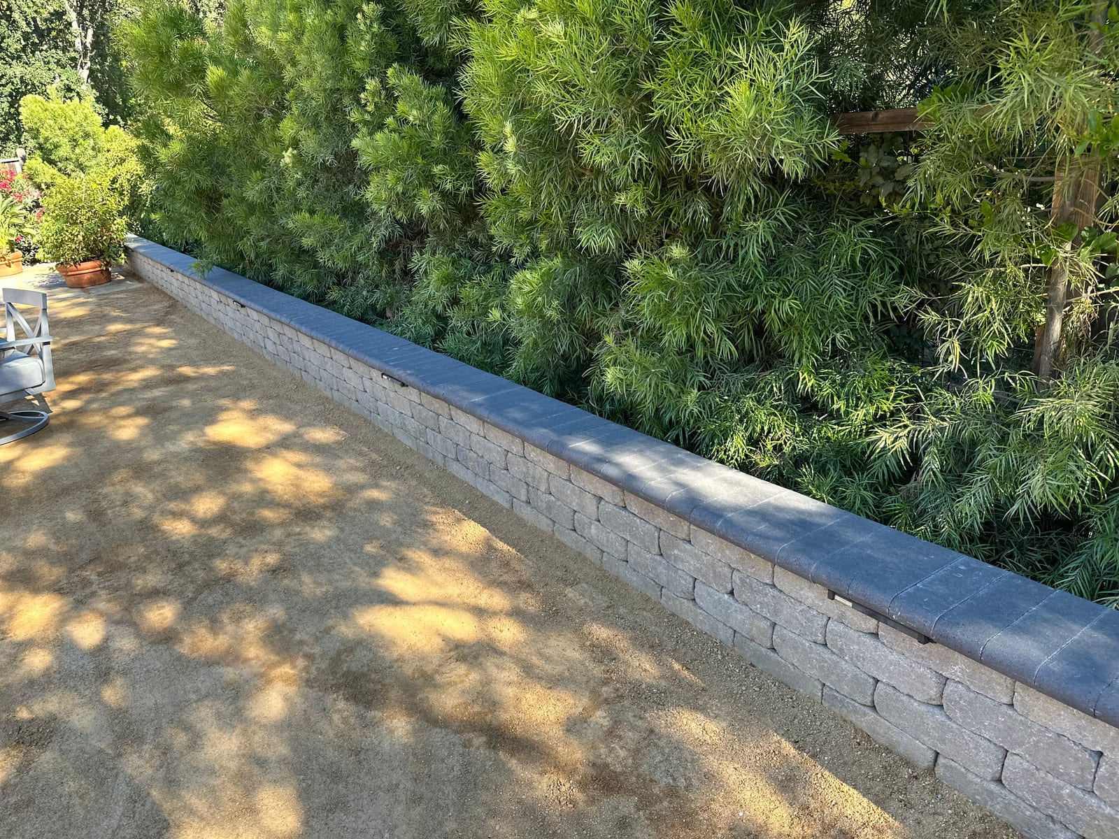 Segmented block retaining wall with paver patio built by Royal Outdoor Solutions on a hillside lot in San Anselmo, CA