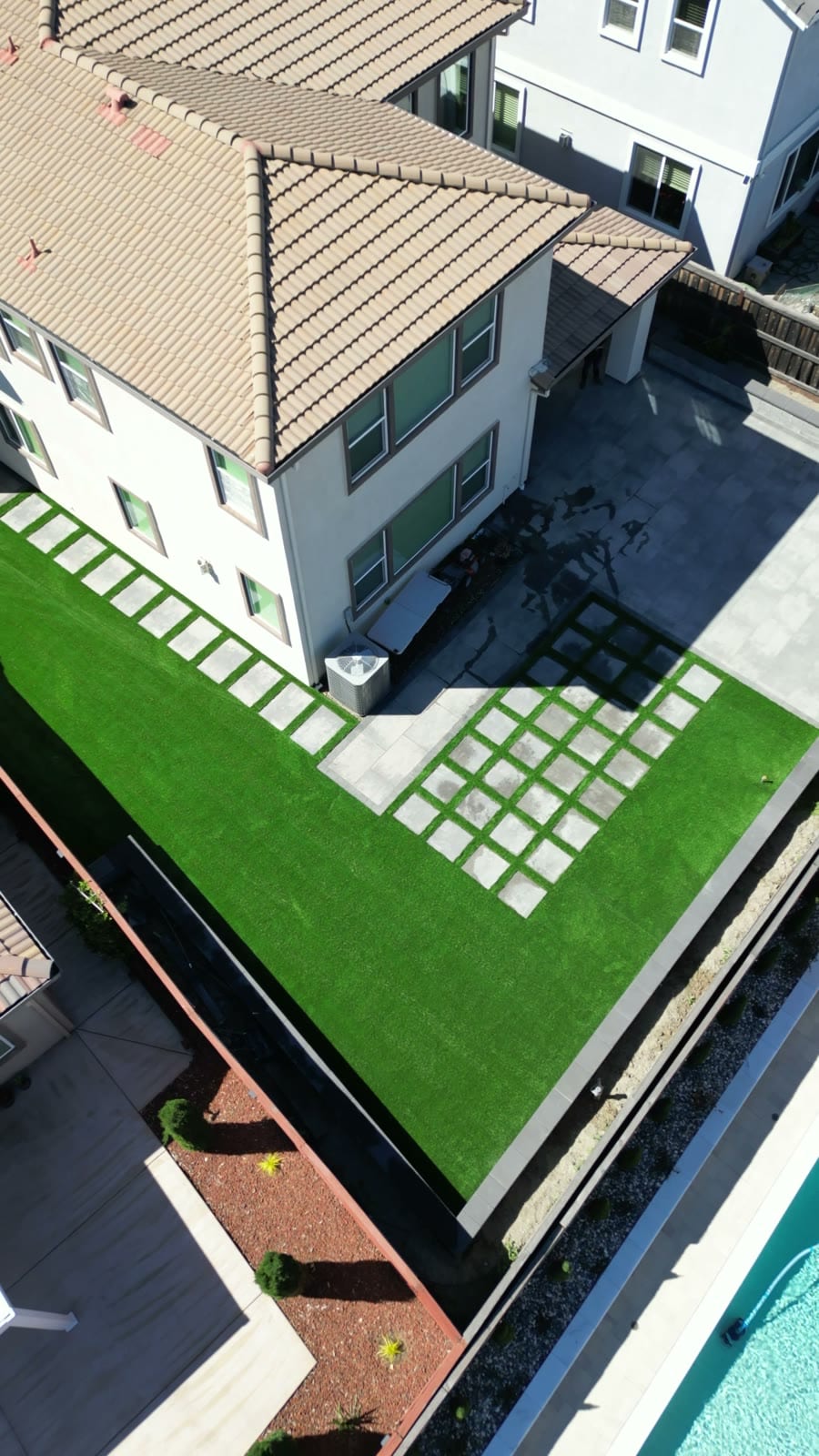 Close aerial view of artificial turf with paver grid checkerboard and patio in Fairfield, CA